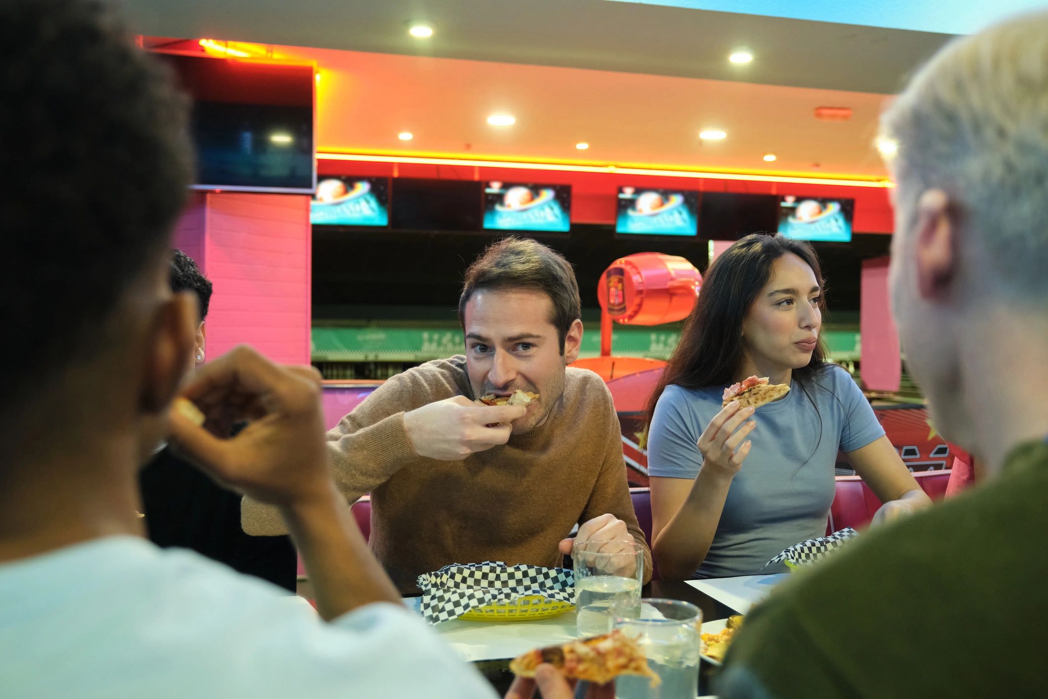 Friends sharing pizza and enjoying time together